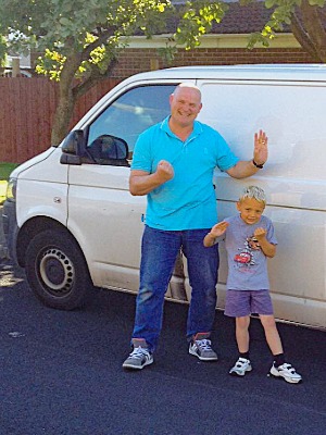 photo of Rikki and his son stood outside thier van